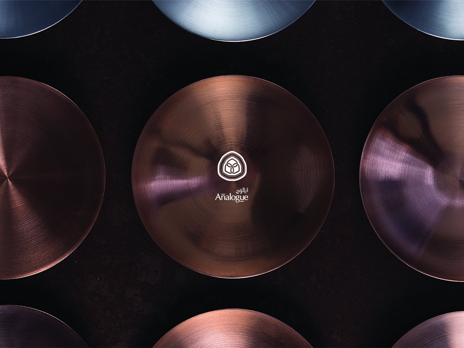 Copper discs laid edge to edge, the Analogue seal struck at the centre of one