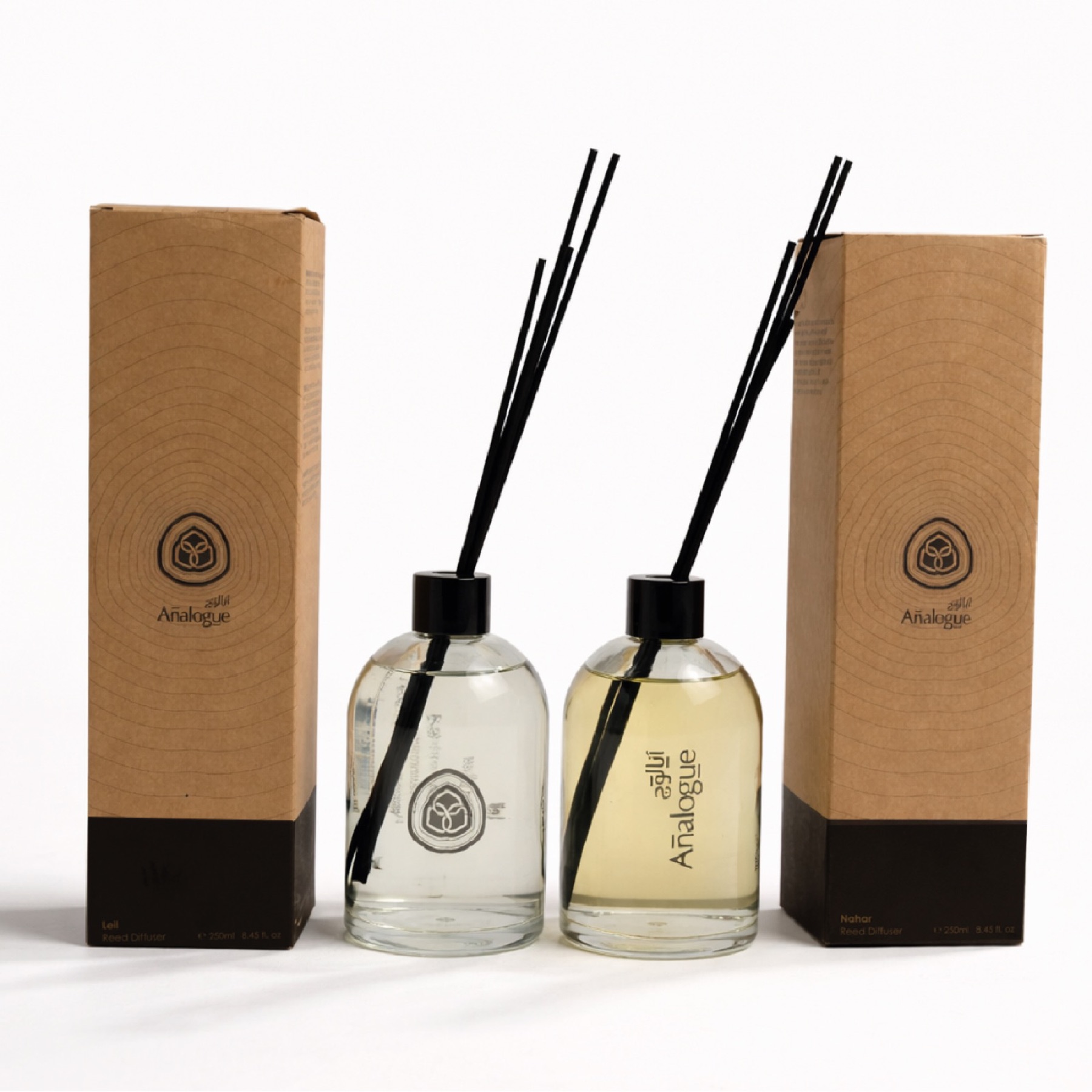 Two reed diffusers, one clear and one amber