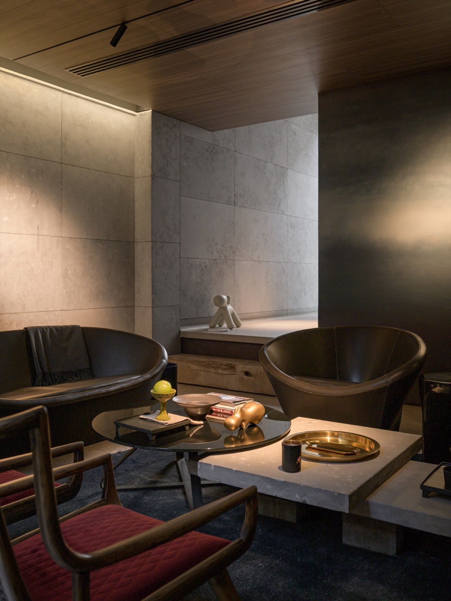 A lounge with low seating and a bronze table